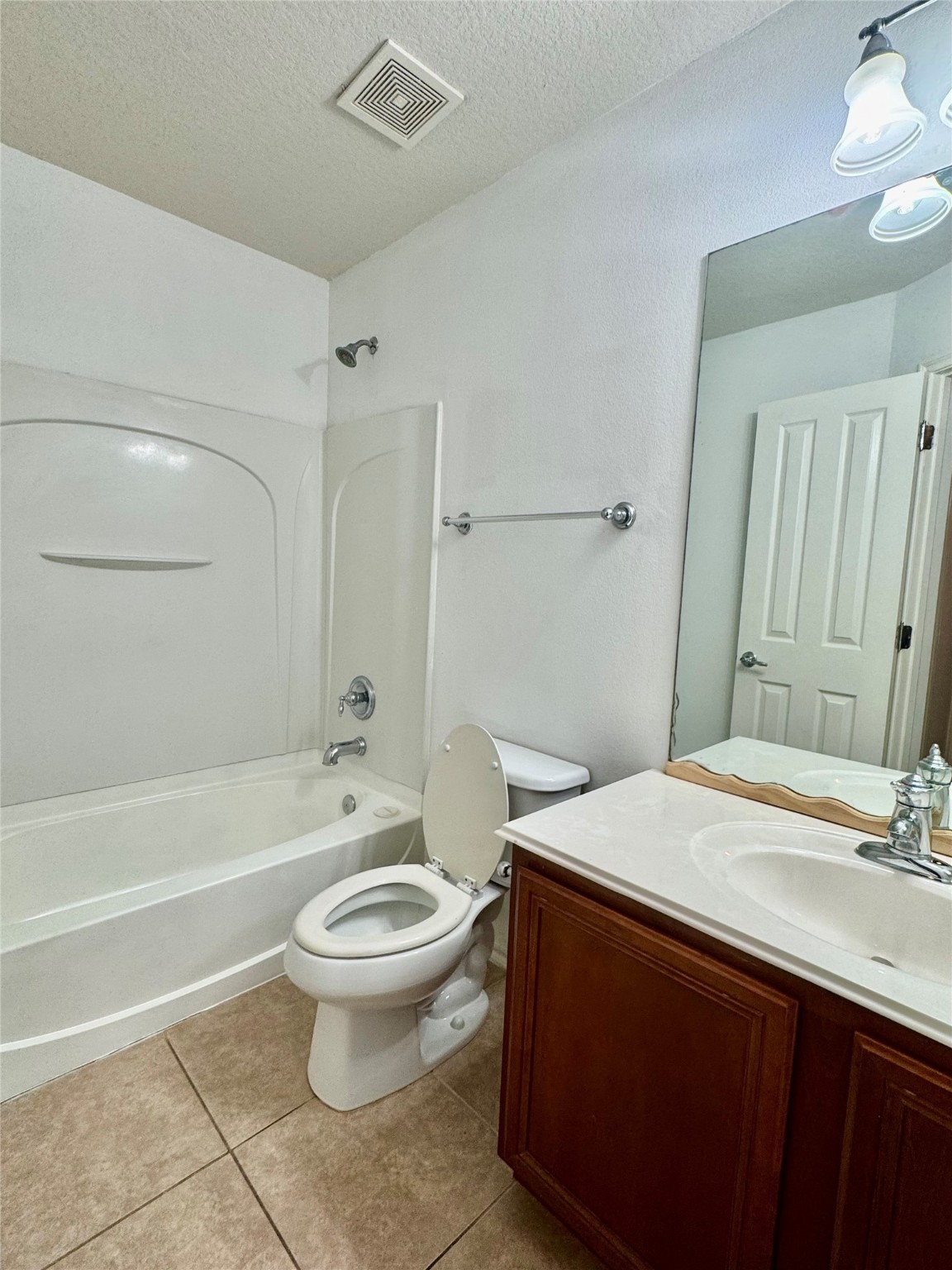 13600 Breton Ridge Street, Unit 36C Houston, TX 77070 - Photo 7 of 40 a bathroom with a sink a toilet and a large mirror