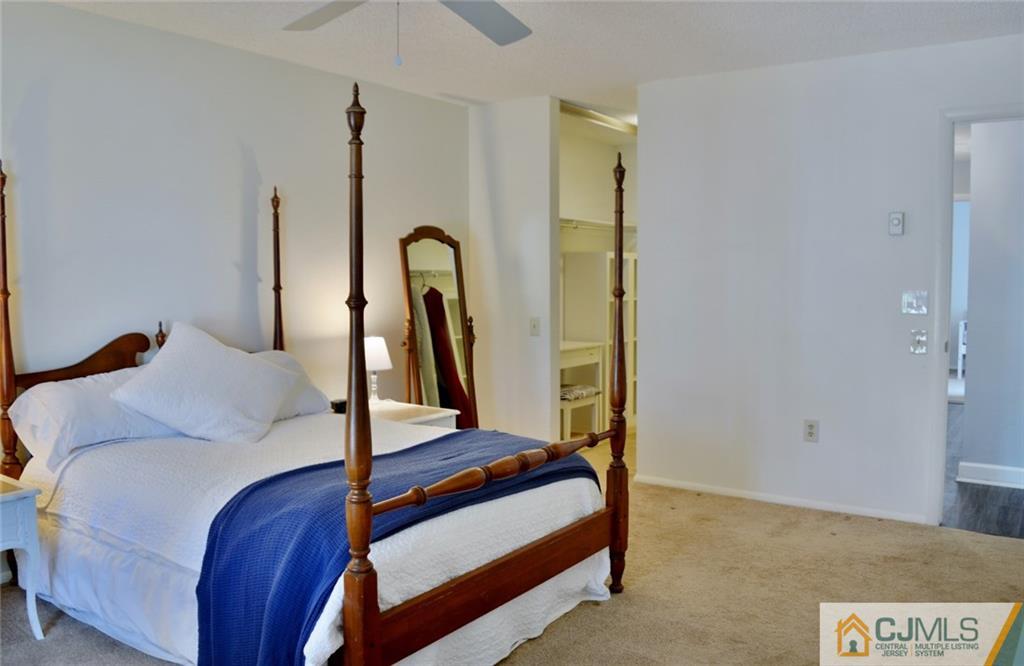 526 B Belford Road Monroe Township, NJ 08831 - Photo 12 of 13 a bedroom with a bed and a potted plant