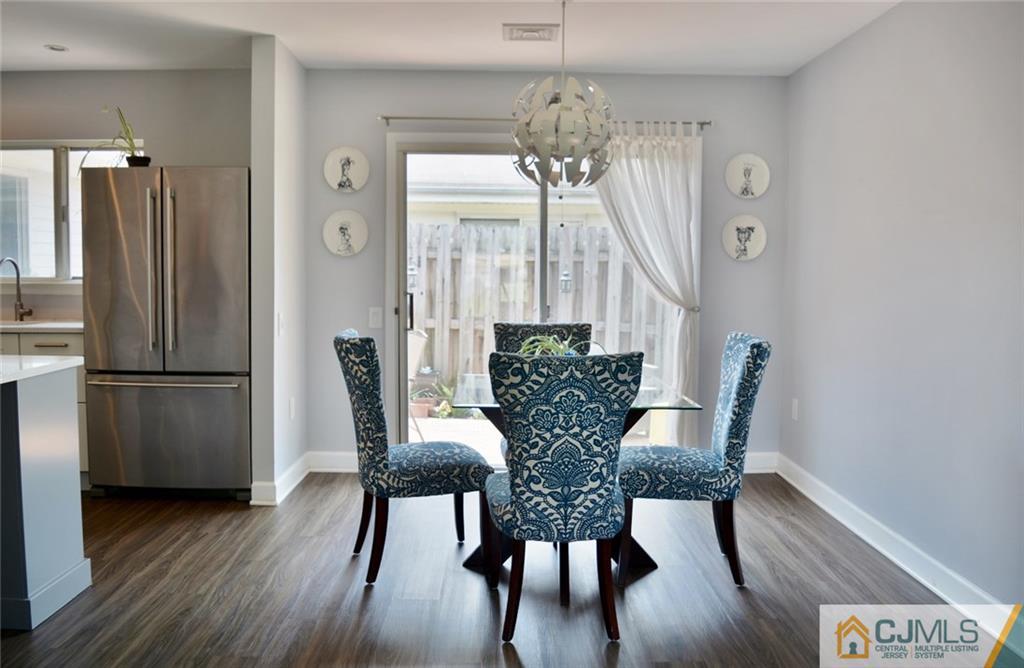 526 B Belford Road Monroe Township, NJ 08831 - Photo 3 of 13 a view of a dining room with furniture window and wooden floor