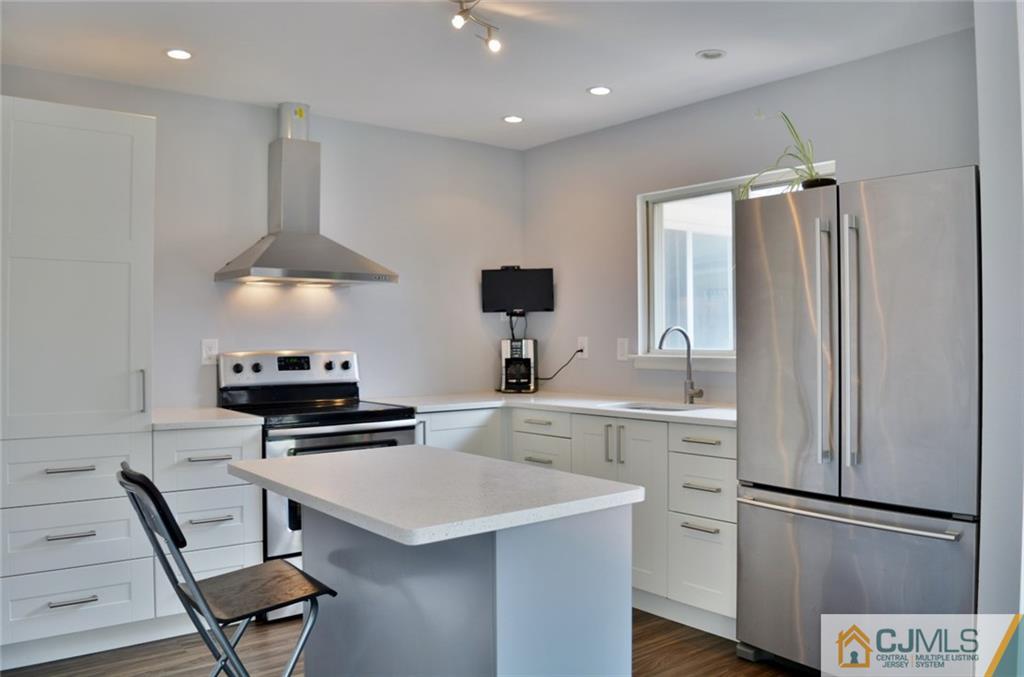 526 B Belford Road Monroe Township, NJ 08831 - Photo 6 of 13 a kitchen with a refrigerator a stove a sink and a cabinets