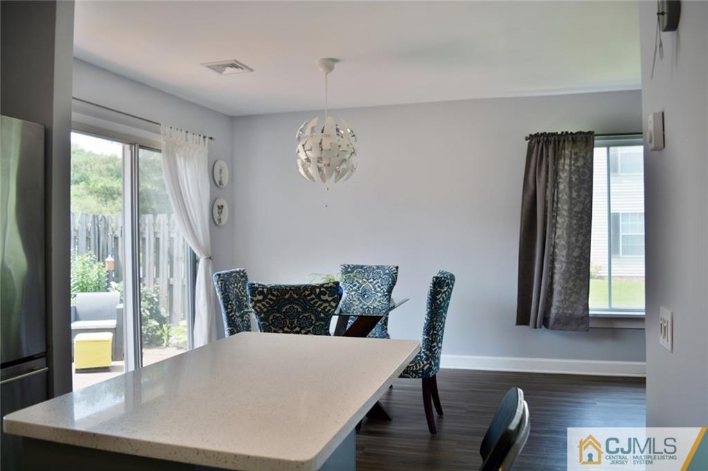 526 B Belford Road Monroe Township, NJ 08831 - Photo 7 of 13 a view of a dining room with furniture and wooden floor