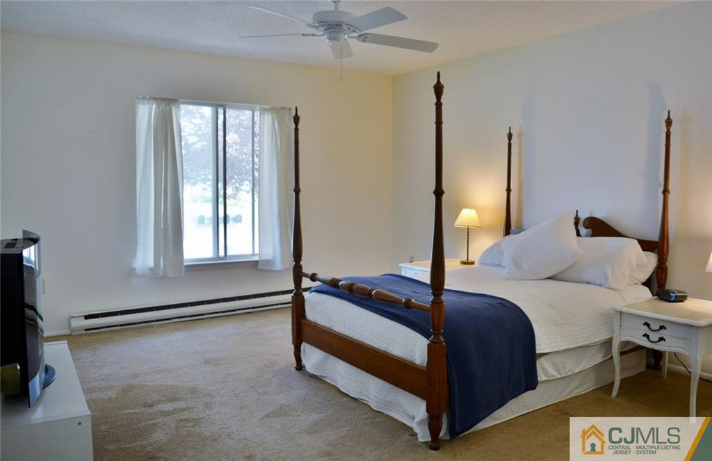 526 B Belford Road Monroe Township, NJ 08831 - Photo 10 of 13 a spacious bedroom with a bed and a flat screen tv
