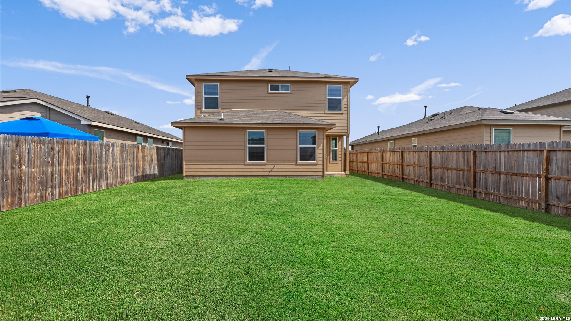 6819 Rondo Measure San Antonio, TX 78252 - Photo 17 of 25 a view of a house with a yard and wooden fence