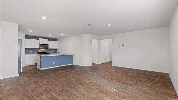 a kitchen with stainless steel appliances kitchen island granite countertop a stove and a refrigerator