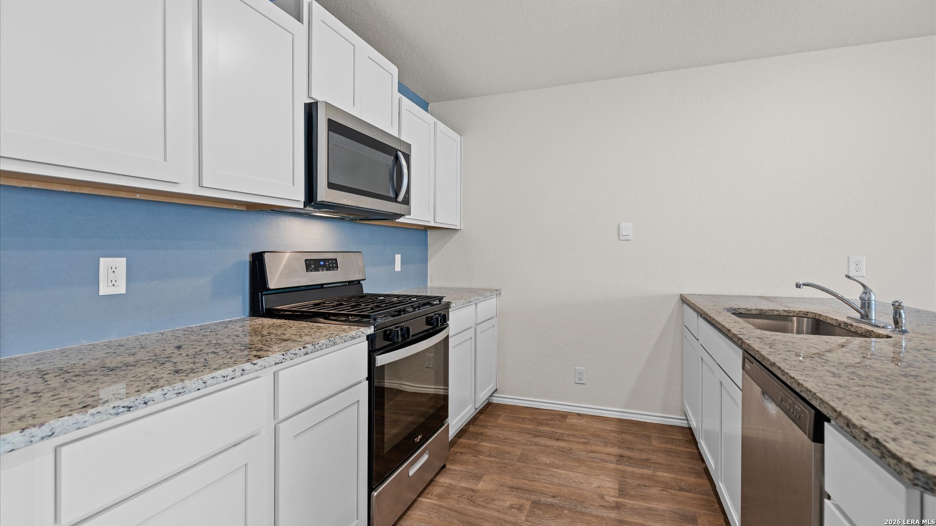 6819 Rondo Measure San Antonio, TX 78252 - Photo 4 of 25 a kitchen with stainless steel appliances granite countertop a sink and a stove