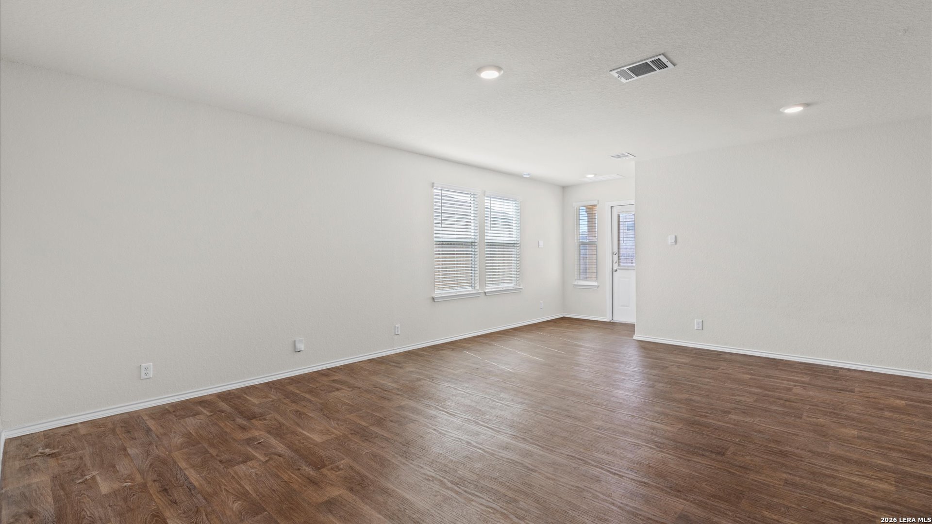 6819 Rondo Measure San Antonio, TX 78252 - Photo 5 of 25 a view of an empty room with closet and wooden floor