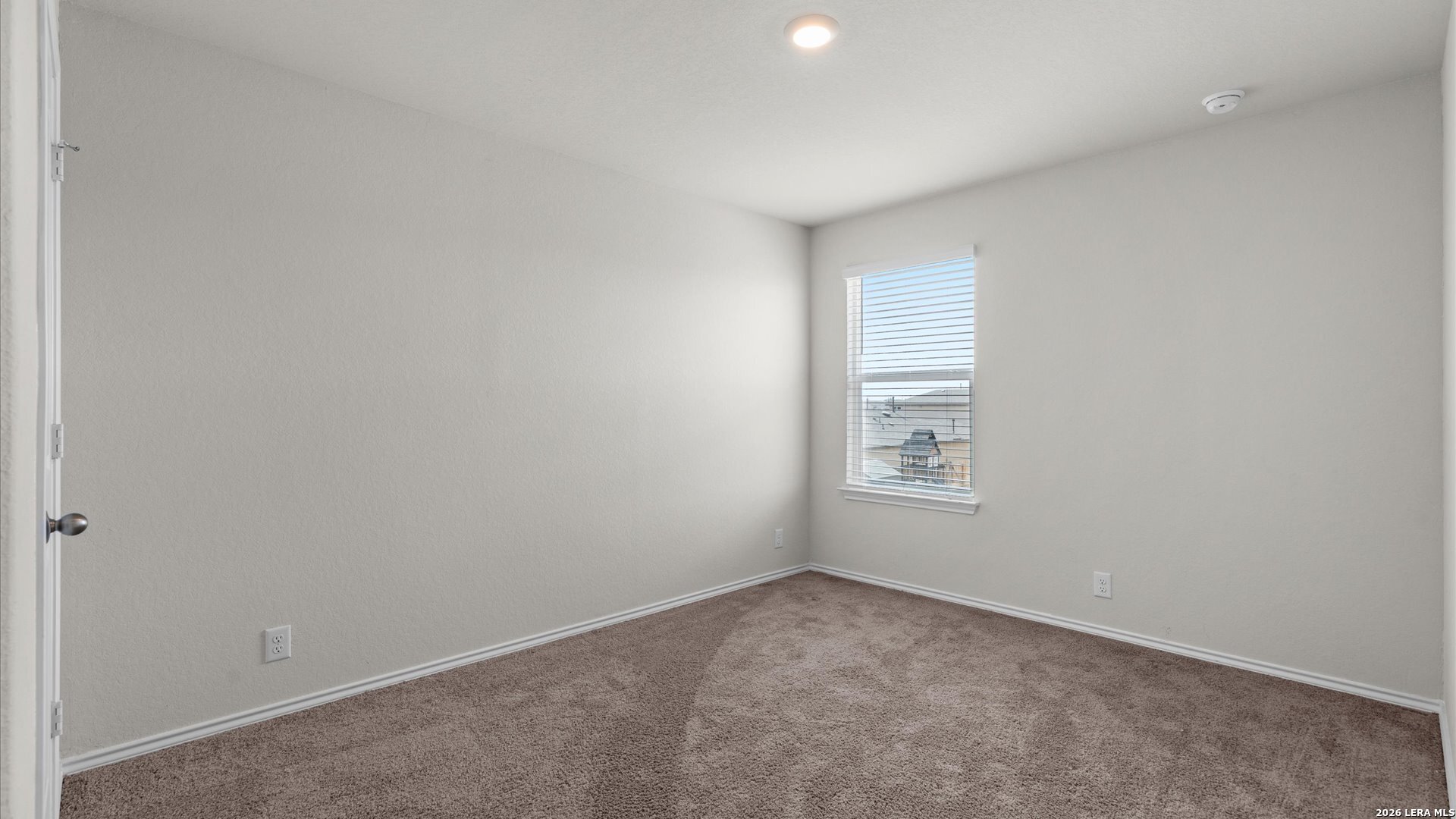 6819 Rondo Measure San Antonio, TX 78252 - Photo 7 of 25 a view of an empty room and a window