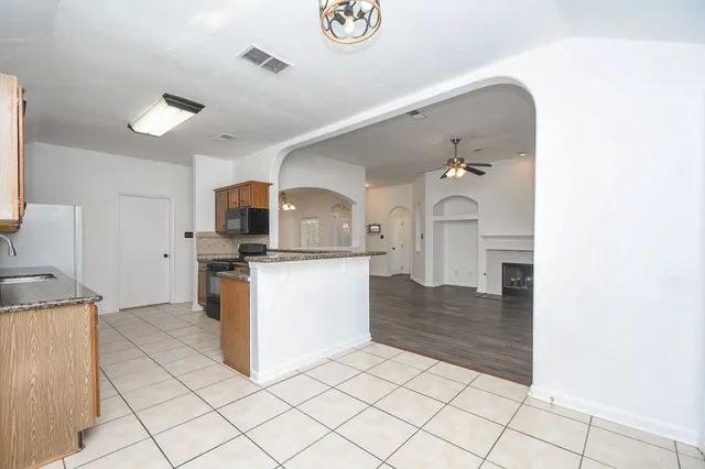 a kitchen with granite countertop a sink and a stove top oven