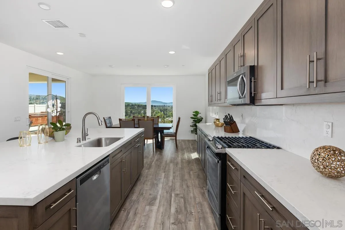 8741 Weston Road Santee, CA 92071 - Photo 11 of 53 a kitchen with granite countertop a sink stove and cabinets