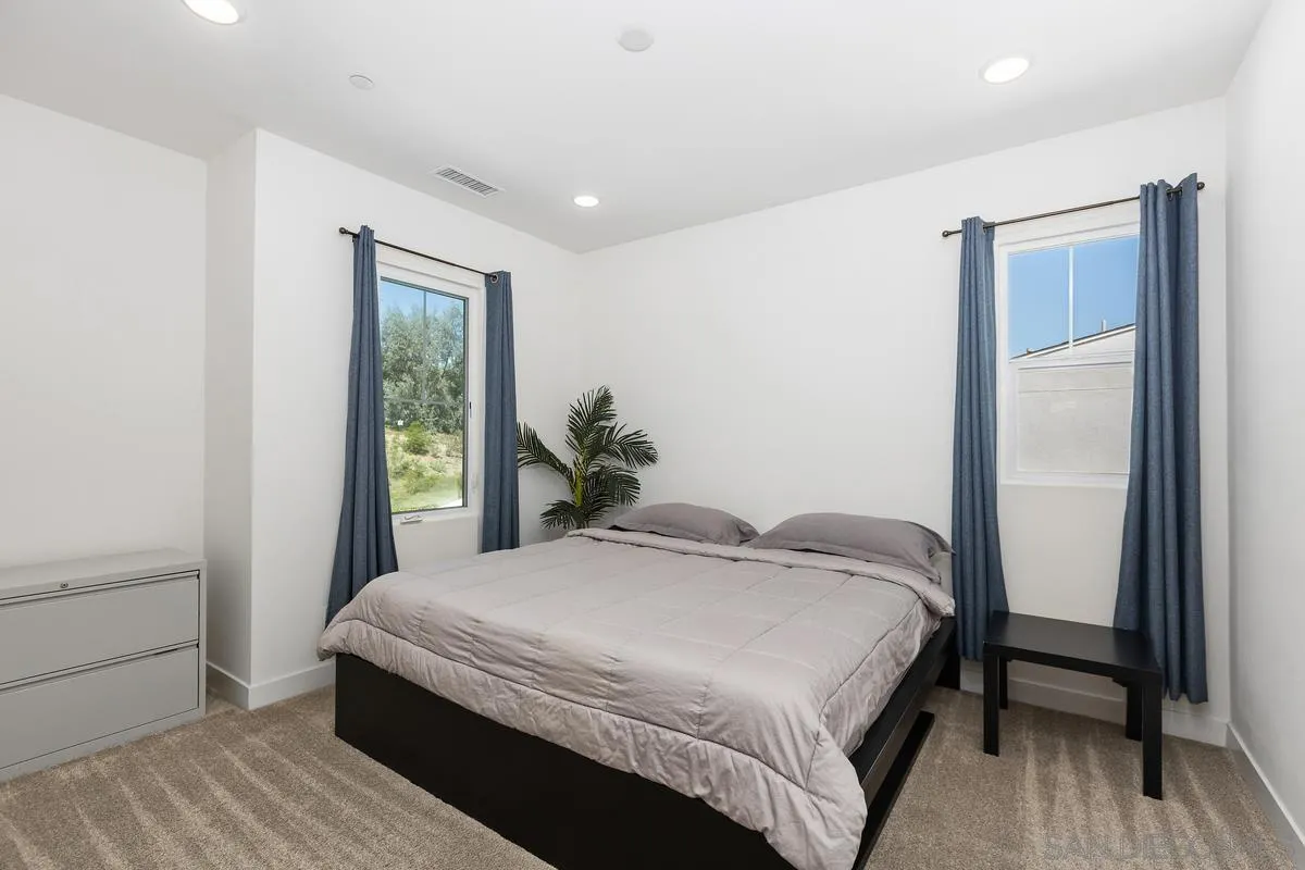 8741 Weston Road Santee, CA 92071 - Photo 25 of 53 a bedroom with a bed and a potted plant