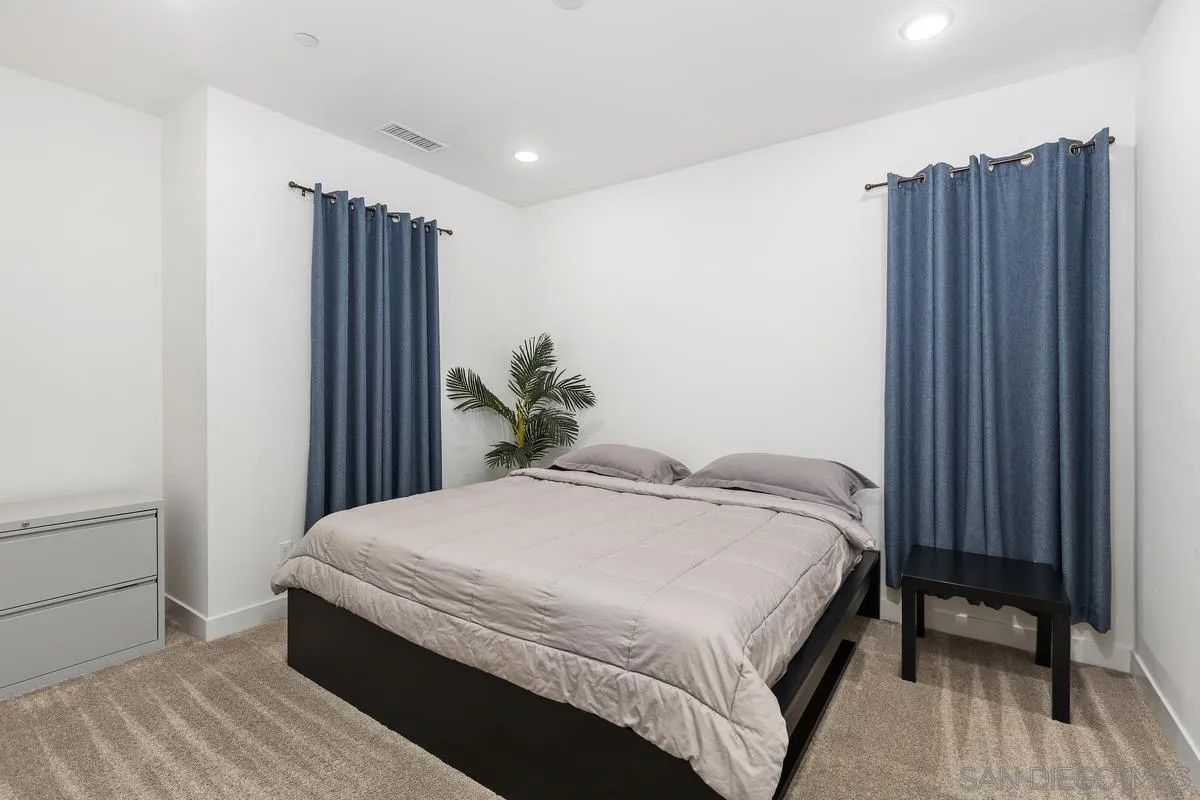 8741 Weston Road Santee, CA 92071 - Photo 26 of 53 a bedroom with a bed table and a window