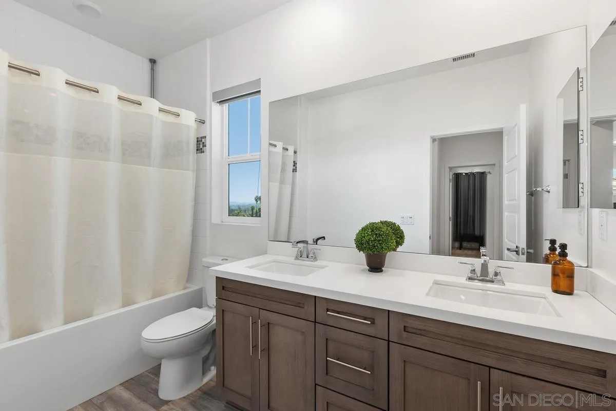 8741 Weston Road Santee, CA 92071 - Photo 27 of 53 a bathroom with a double vanity sink toilet and shower