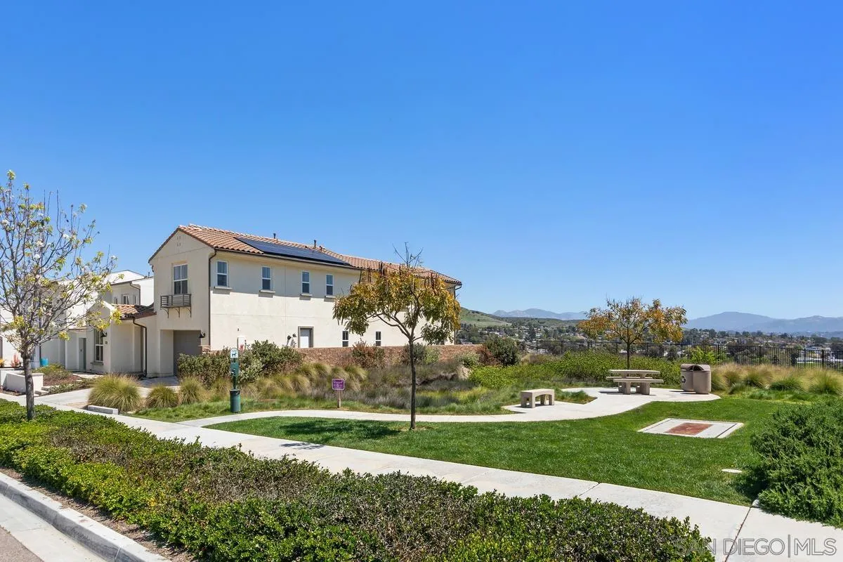 8741 Weston Road Santee, CA 92071 - Photo 35 of 53 a view of a white house in front of a big yard with plants and large trees