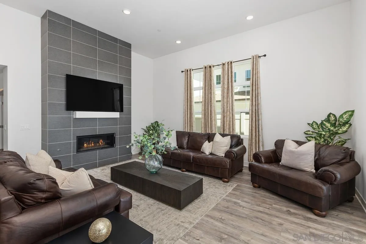 8741 Weston Road Santee, CA 92071 - Photo 5 of 53 a living room with furniture a fireplace and a flat screen tv