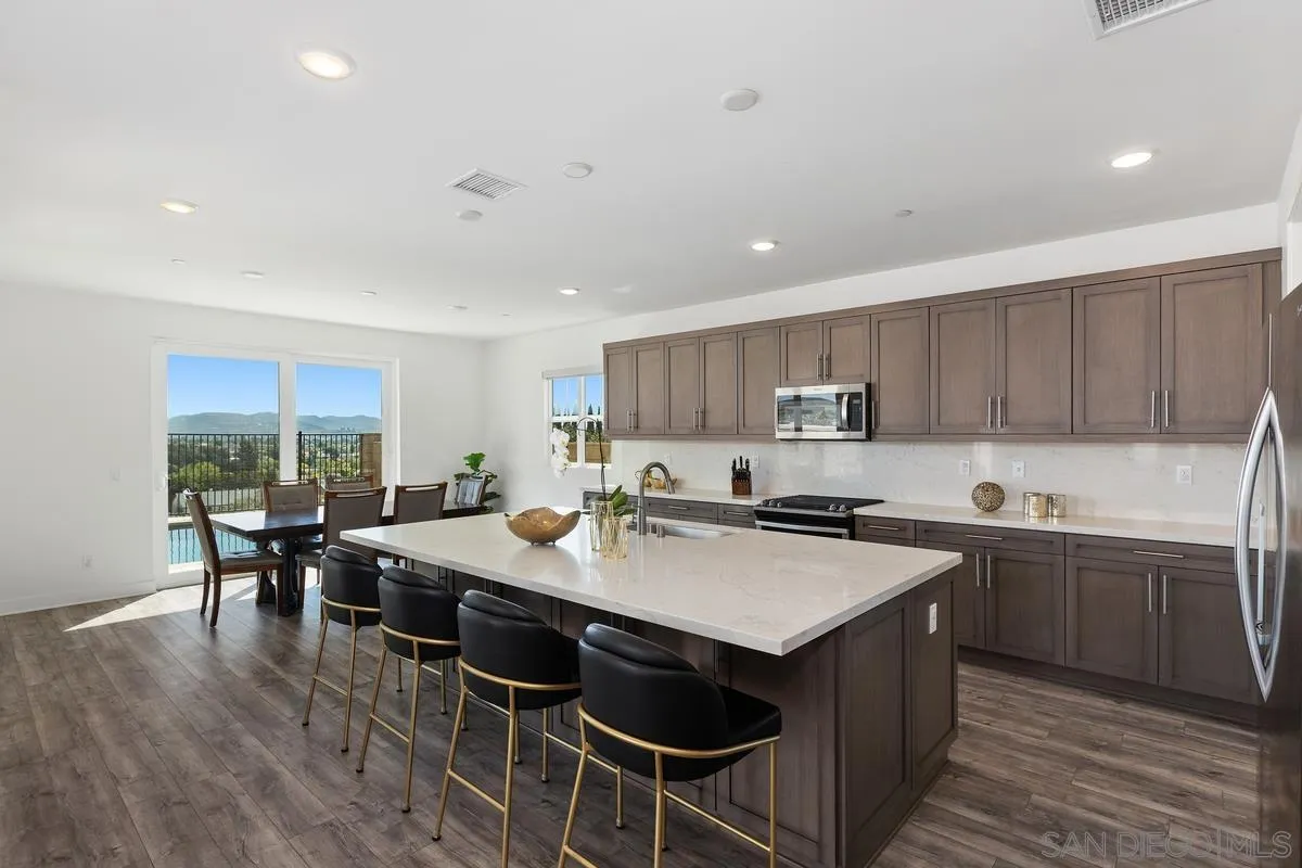 8741 Weston Road Santee, CA 92071 - Photo 9 of 53 a kitchen with a dining table chairs and wooden floor