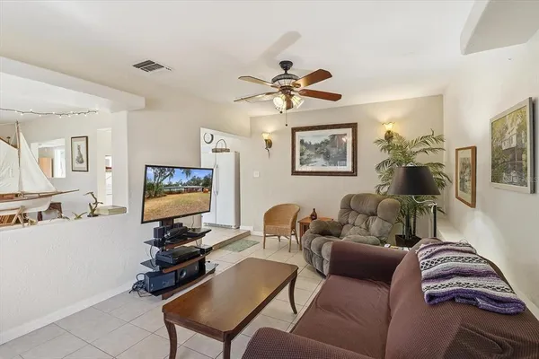 a living room with furniture a couch and a flat screen tv
