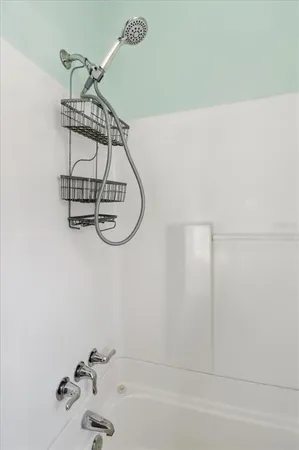 a bathroom with a bathtub and shower