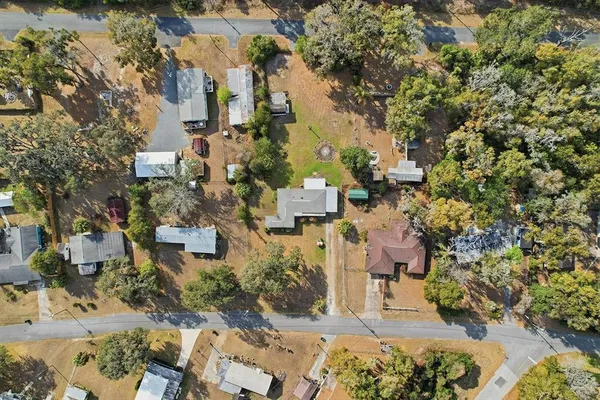 an aerial view of residential houses with outdoor space