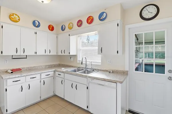a kitchen with cabinets a sink and appliances