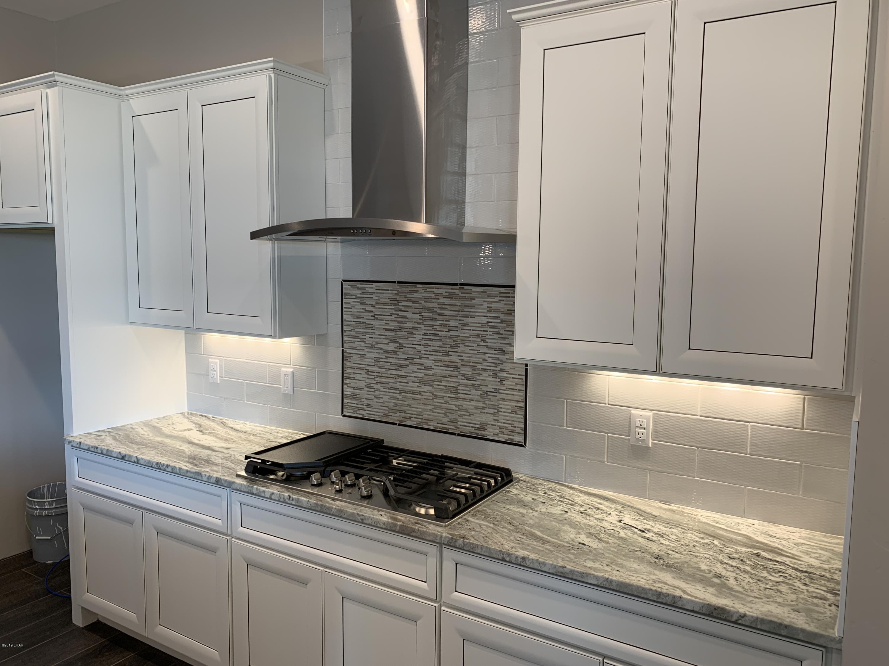4731 North Juneberry Road Lake Havasu City, AZ 86404 - Photo 13 of 52 a kitchen with granite countertop a stove and cabinets