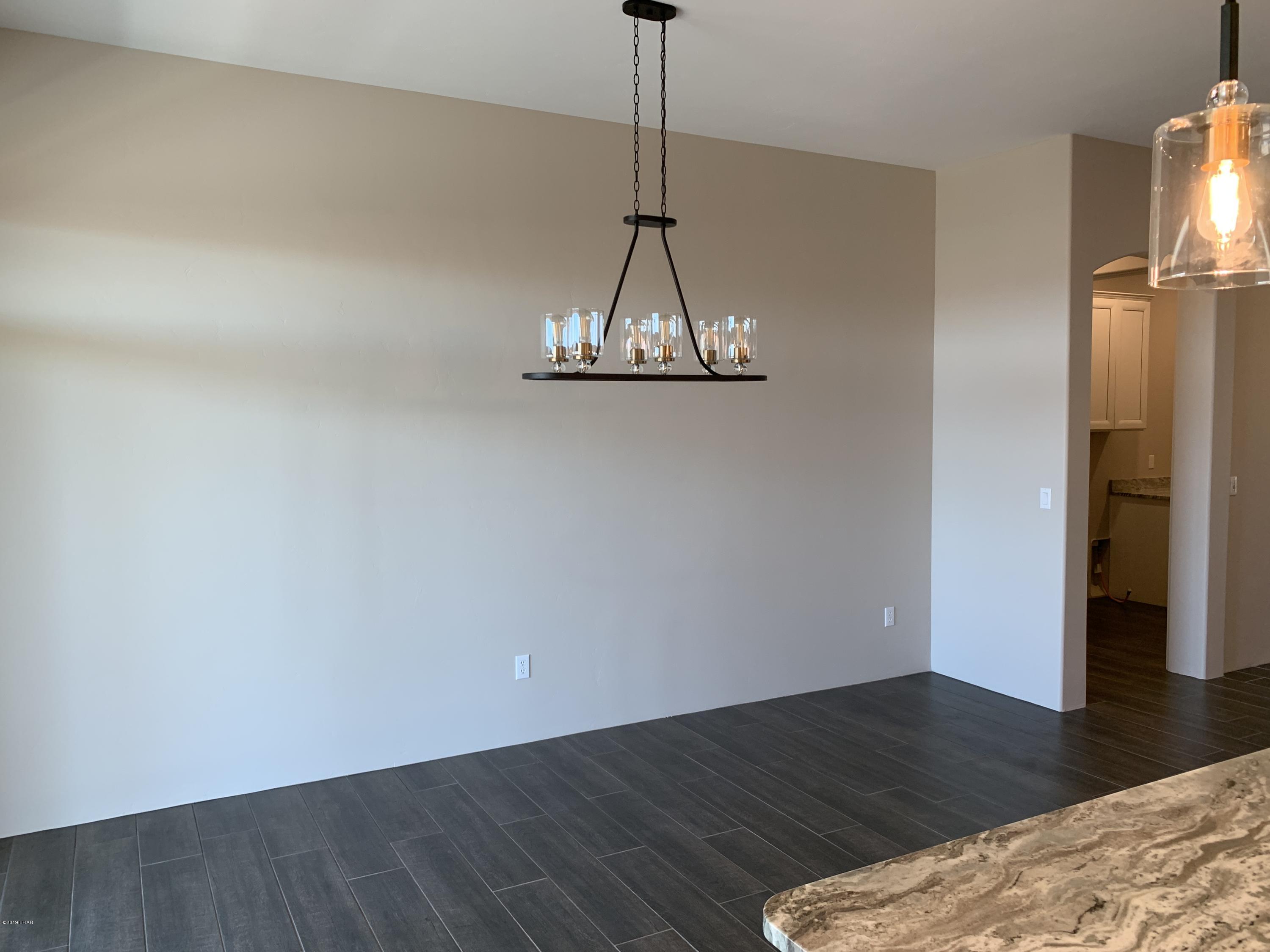 4731 North Juneberry Road Lake Havasu City, AZ 86404 - Photo 21 of 52 a view of a room with wooden floor and a ceiling fan