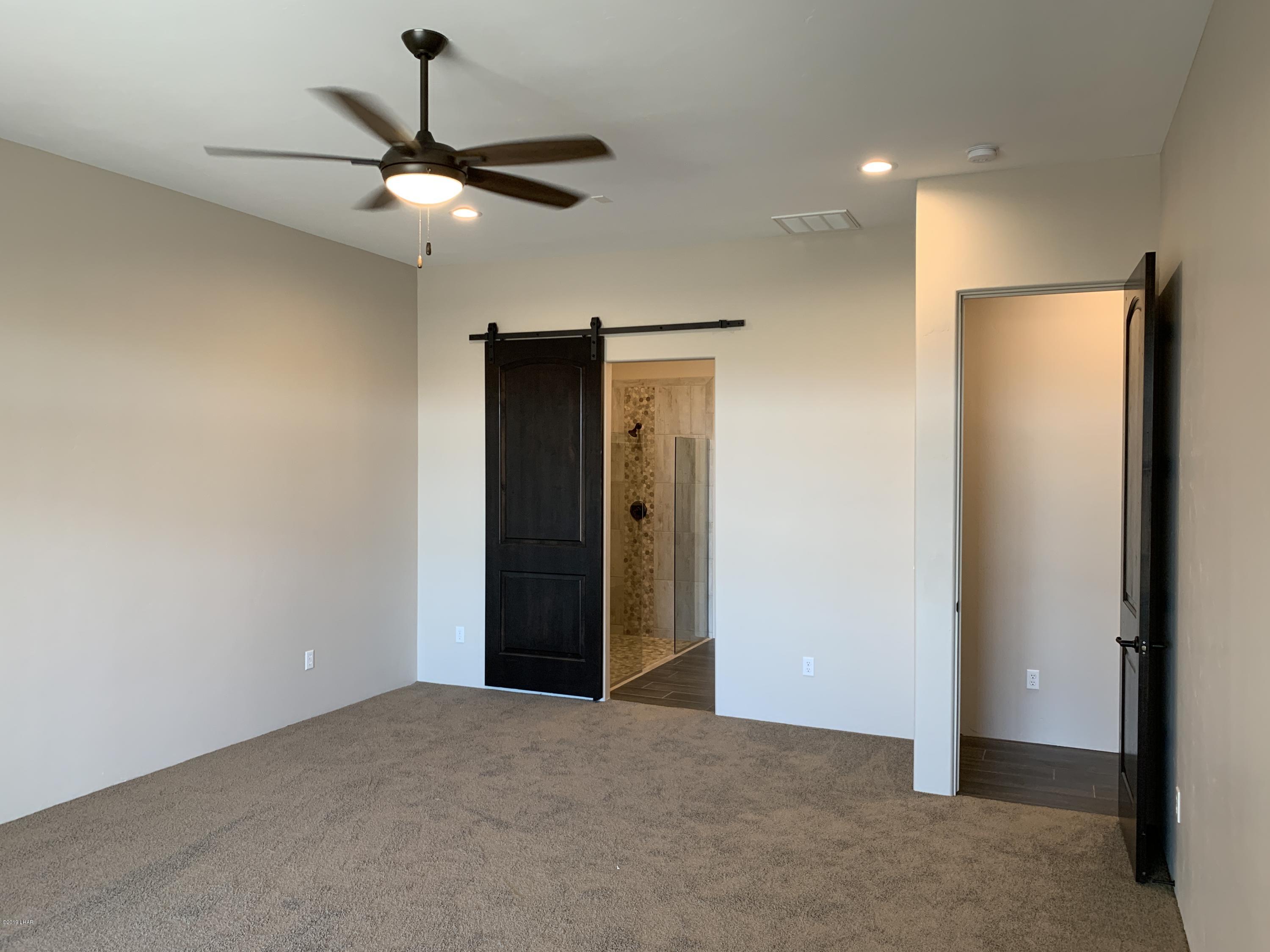 4731 North Juneberry Road Lake Havasu City, AZ 86404 - Photo 23 of 52 a view of an empty room with a ceiling fan