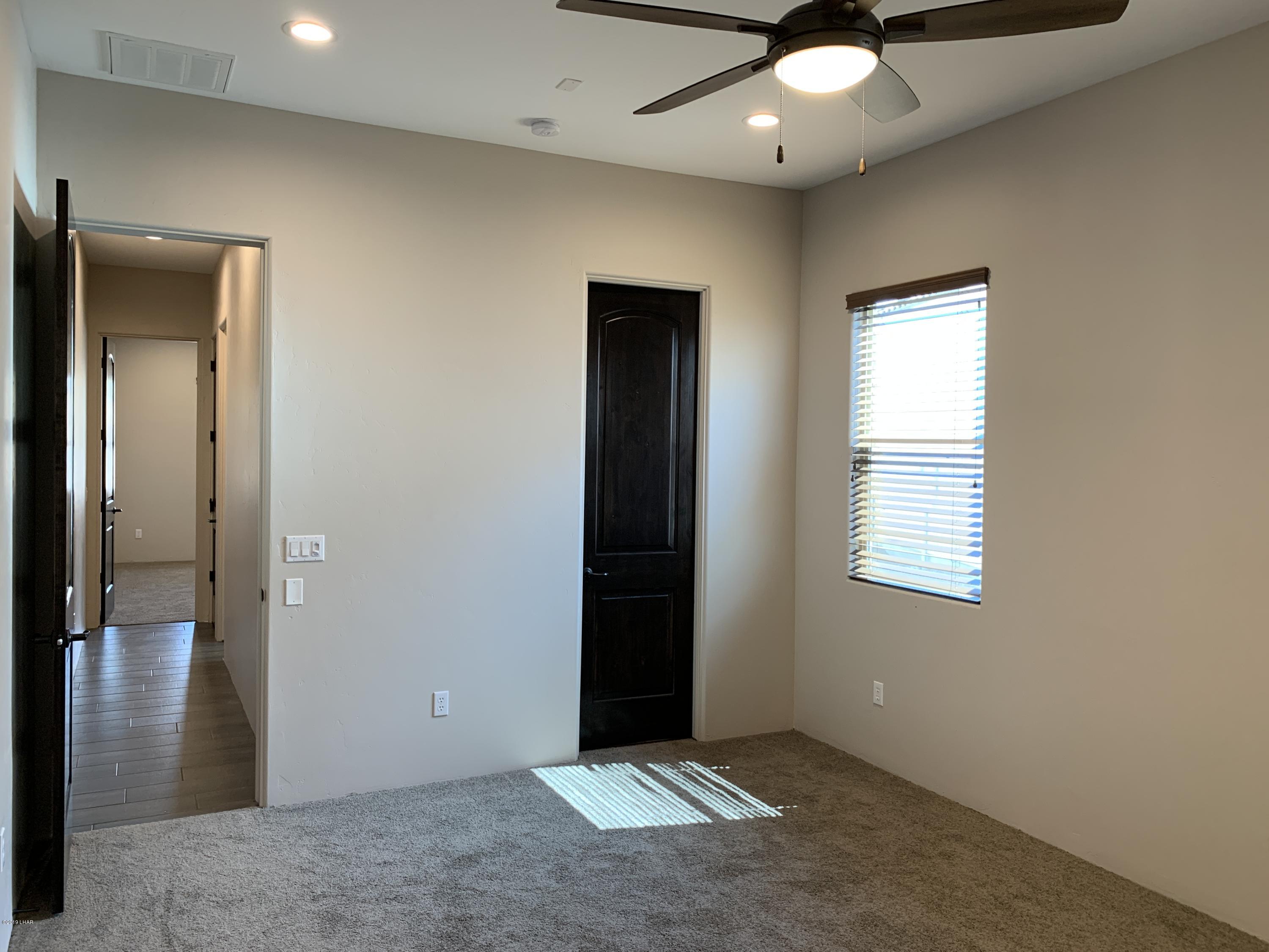 4731 North Juneberry Road Lake Havasu City, AZ 86404 - Photo 30 of 52 an empty room with closet and a chandelier fan
