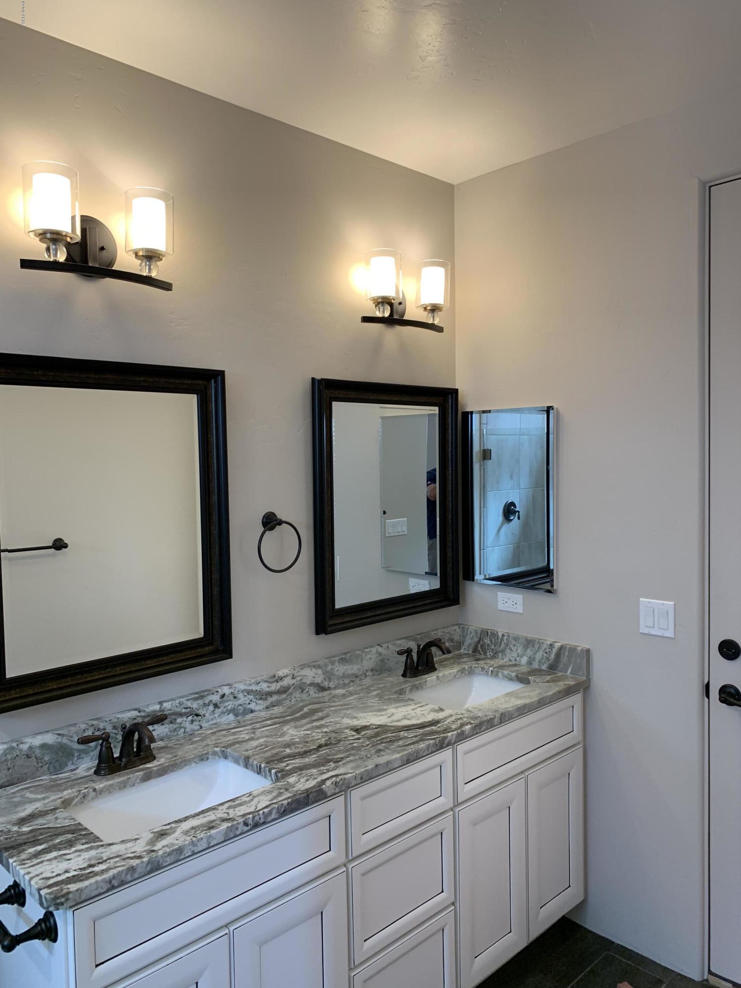 4731 North Juneberry Road Lake Havasu City, AZ 86404 - Photo 34 of 52 a bathroom with double vanity sinks and a mirror