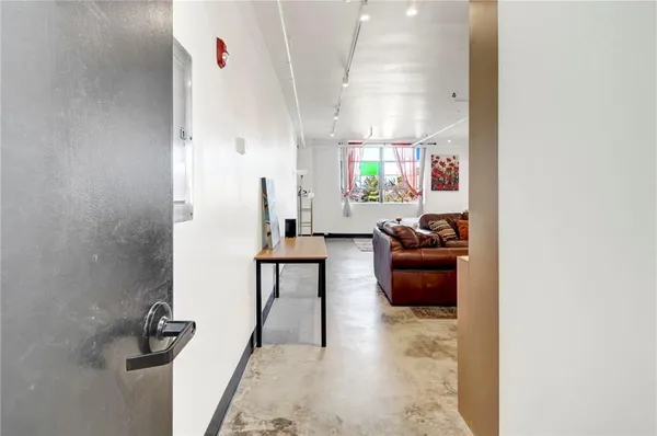 a living room with furniture and a rug