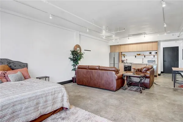 a bedroom with furniture and a large window
