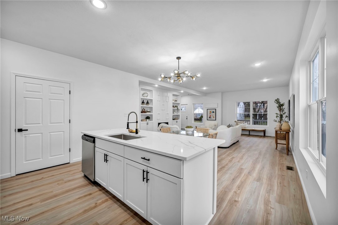 3734 Pennington Road Cleveland, OH 44120 - Photo 12 of 45 Kitchen with recessed lighting, white cabinetry, light wood finished floors, light stone countertops, and decorative light fixtures