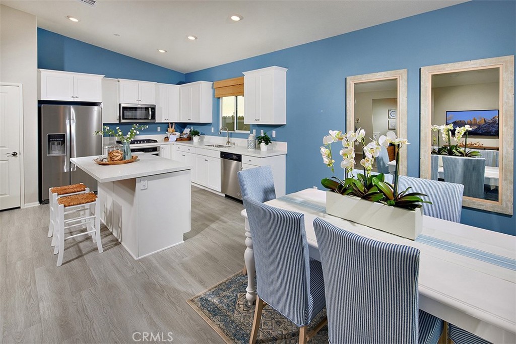 28484 Memory Lane Winchester, CA 92596 - Photo 5 of 12 a kitchen with white cabinets and stainless steel appliances