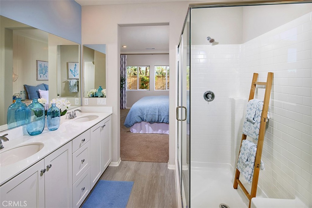 28484 Memory Lane Winchester, CA 92596 - Photo 10 of 12 a spacious bathroom with a double vanity sink a mirror a shower and a bathtub