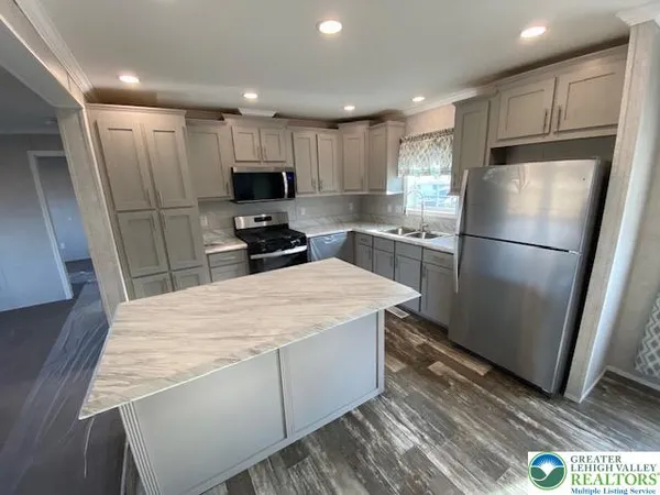 a kitchen with a refrigerator a sink and cabinets
