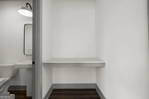 a bathroom with a toilet a sink and mirror