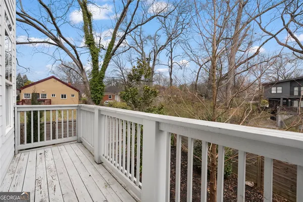 a view of a wooden deck besides a house
