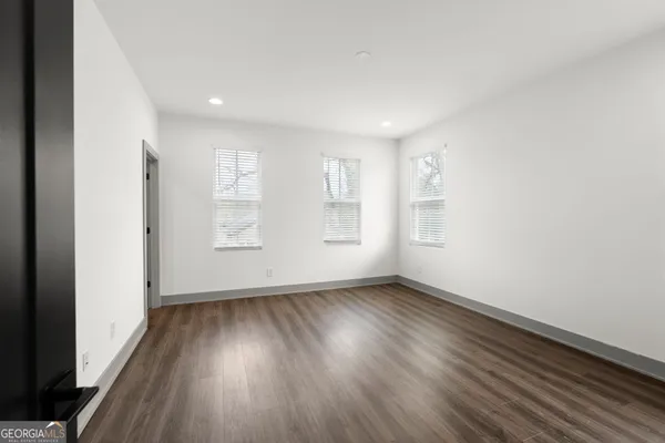 a view of an empty room with wooden floor