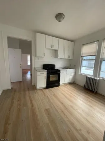 a large kitchen with a stove and large window