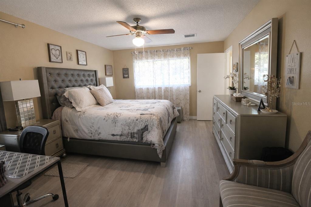 5046 Kenmore Street Spring Hill, FL 34608 - Photo 5 of 19 a bedroom with a bed and a couch