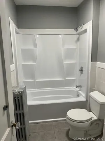 a bathroom with a toilet and a shower