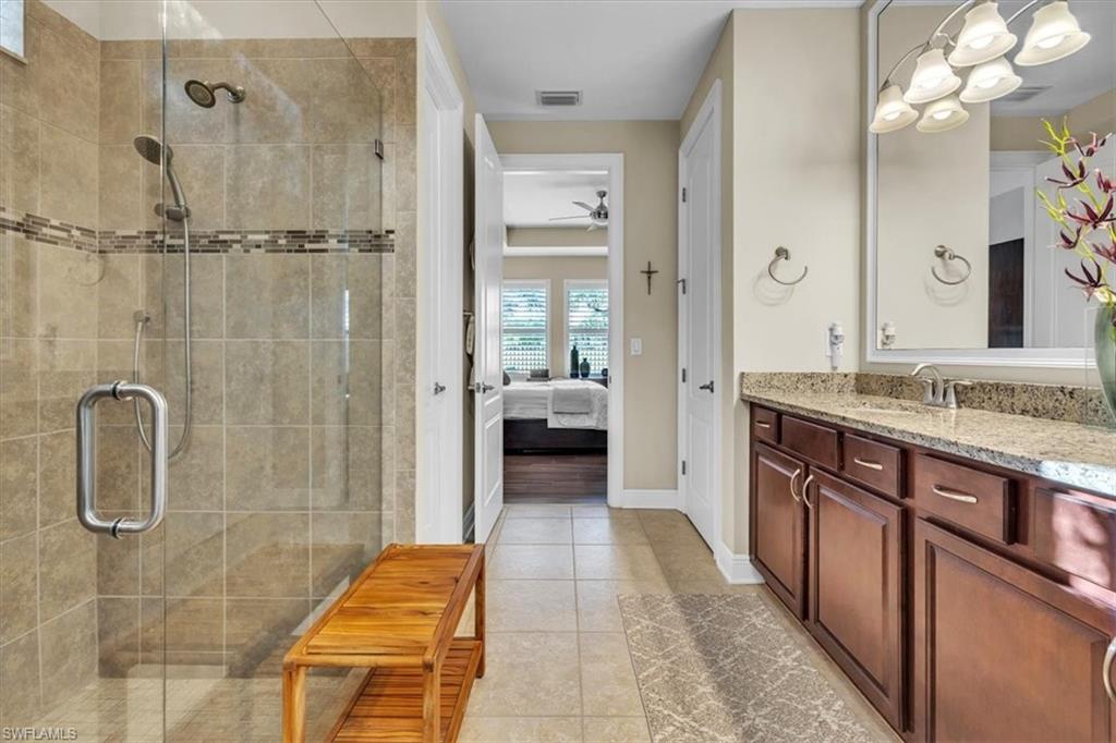 16424 Windsor Way Alva, FL 33920 - Photo 22 of 48 a bathroom with a granite countertop sink a mirror and shower