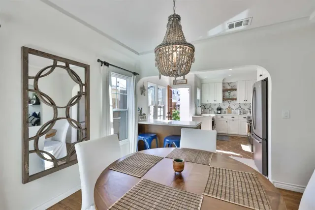 a living room with furniture a chandelier and a table