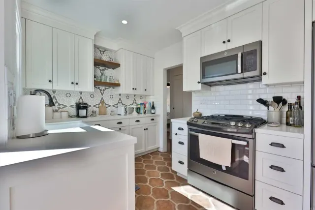 a kitchen with a sink cabinets and window