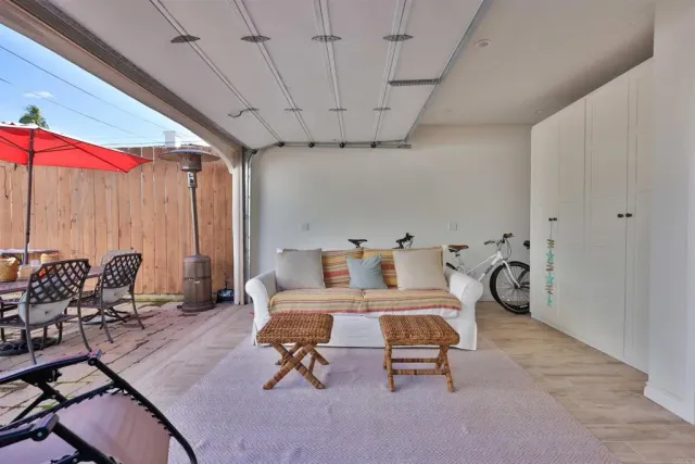 a living room with furniture a flat screen tv and a large window