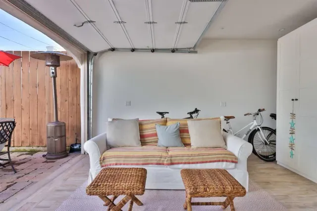 a living room with furniture a flat screen tv and a large window