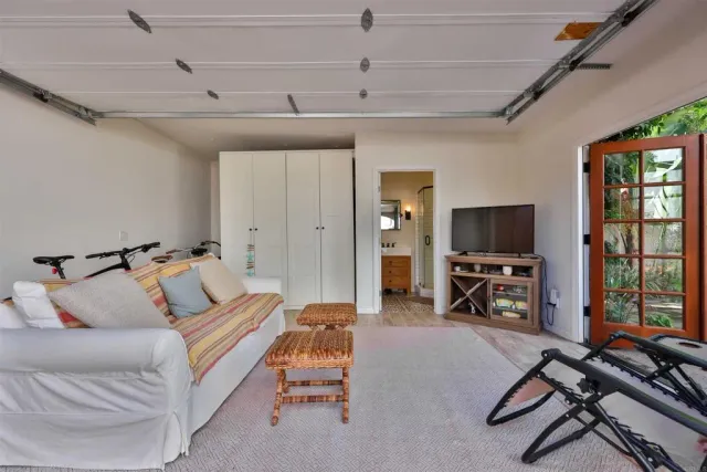 a bathroom with a shower a mirror and a sink
