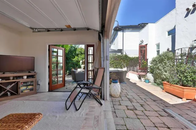 a view of a patio with couches and potted plants