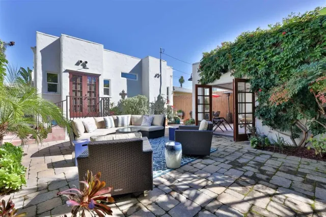 a view of a patio with a table and chairs under an umbrella
