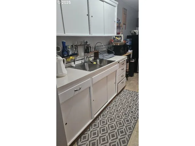 a kitchen with a sink and cabinets
