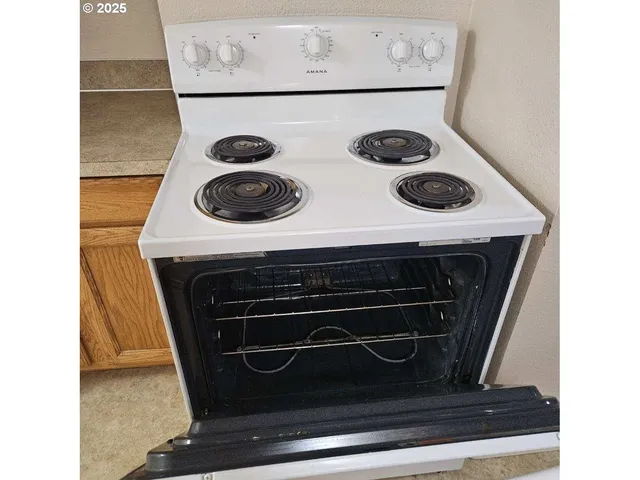 a stove top oven sitting inside of a kitchen